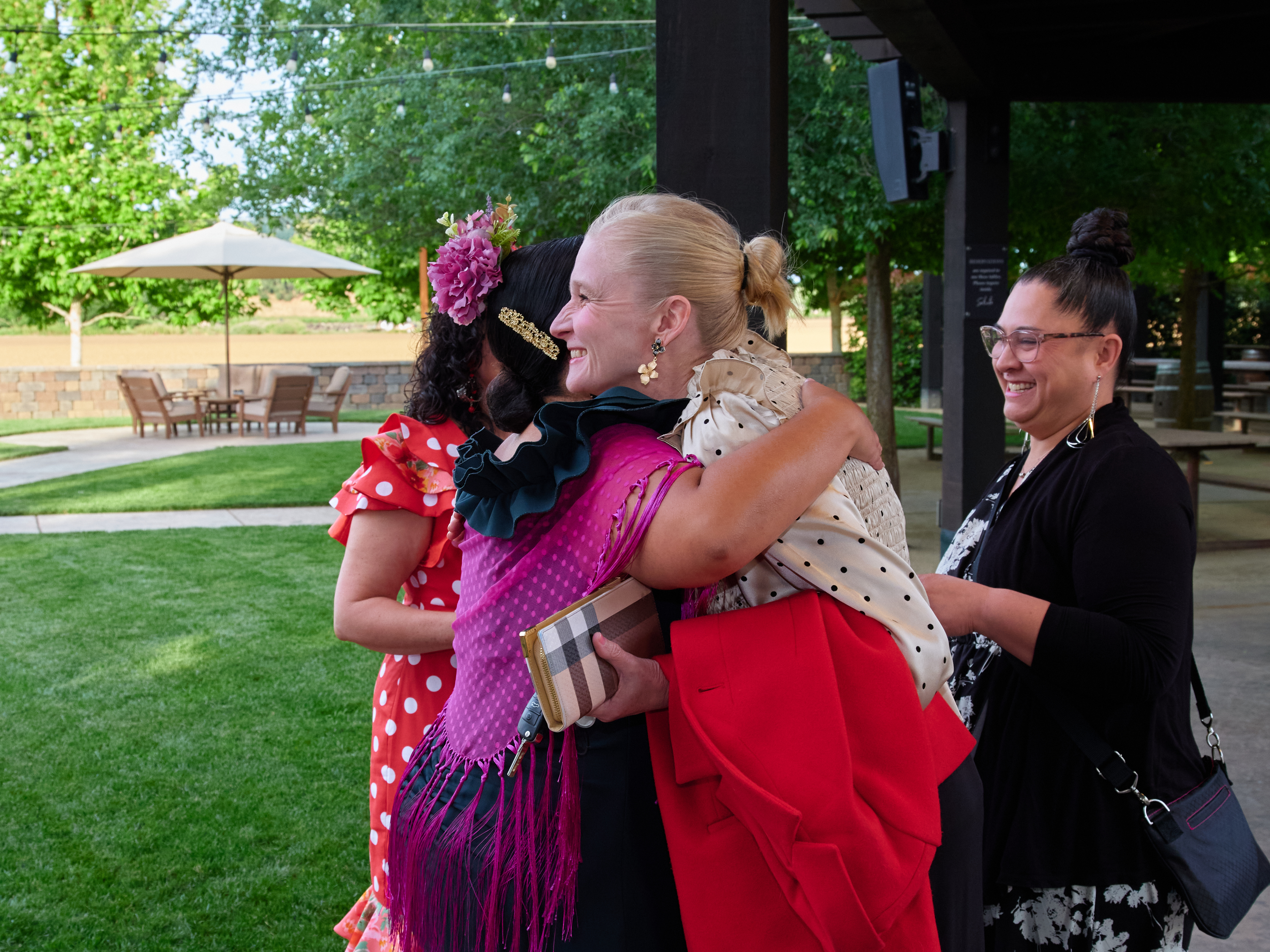 Community members embracing at Feria de Abril